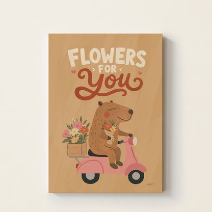 Hand-drawn bear riding a pink scooter carrying flowers with the text Flowers For You, whimsical kids wall art poster for nursery, bedroom, and playroom decor.