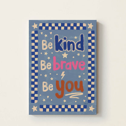 Hand-drawn blue typography poster displaying the affirmation “Be Kind, Be Brave, Be You” in colourful retro lettering with stars and a checkerboard border, positive wall art for children’s bedrooms, nurseries, playrooms, and classrooms.