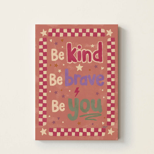 Hand-drawn typography poster featuring the inspirational message "Be Kind, Be Brave, Be You" in colourful retro lettering with a vintage checkerboard border, kids wall art for nurseries, bedrooms, playrooms, and classrooms.