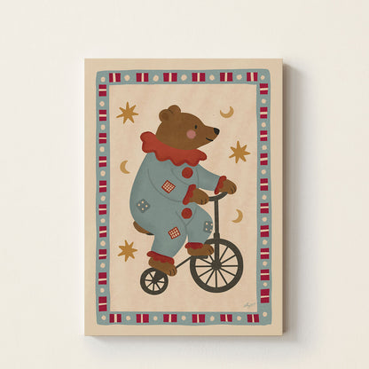 Circus Bear poster featuring a bear in a colorful circus costume riding a vintage bicycle surrounded by stars and moon details on a warm neutral background.