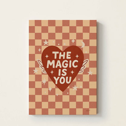 Hand-drawn typography poster featuring a red heart with wings and the uplifting message "The Magic Is You", inspirational kids wall art for nurseries, bedrooms, and playrooms.