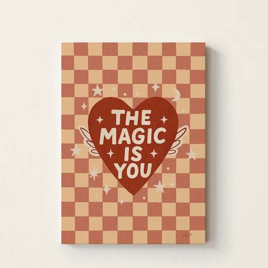 Hand-drawn typography poster featuring a red heart with wings and the uplifting message "The Magic Is You", inspirational kids wall art for nurseries, bedrooms, and playrooms.