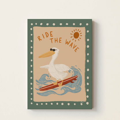 Hand-drawn pelican wearing sunglasses while surfing on a red surfboard beneath the words "Ride the Wave", retro-inspired surf wall art for nurseries, children's bedrooms, playrooms, and beach houses.