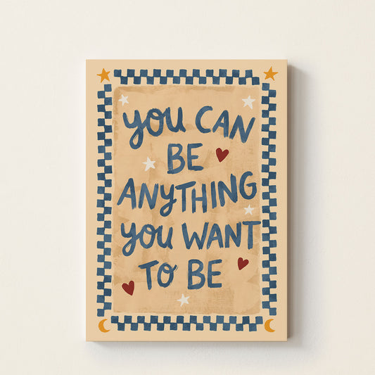 Inspirational typography poster featuring the phrase "You Can Be Anything You Want To Be" with decorative hearts and patterned border on a warm neutral background.