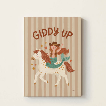 Hand-drawn mermaid dressed as a cowgirl riding a white pony beneath the words "Giddy Up", whimsical western-inspired kids wall art for nurseries, bedrooms, playrooms, and reading corners.