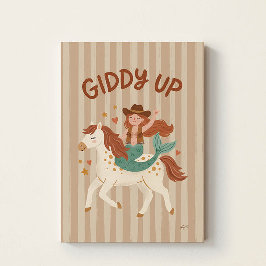 Hand-drawn mermaid dressed as a cowgirl riding a white pony beneath the words "Giddy Up", whimsical western-inspired kids wall art for nurseries, bedrooms, playrooms, and reading corners.