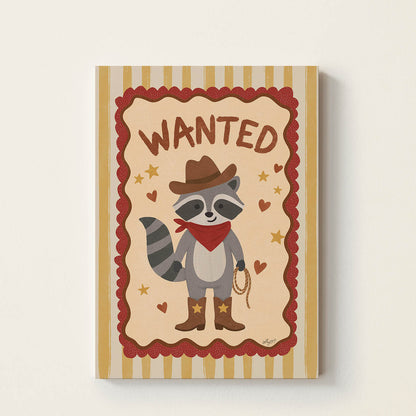 Hand-drawn raccoon dressed as a cowboy wearing boots, a hat, and a bandana beneath the word "Wanted", western-inspired wall art for nurseries, children's bedrooms, playrooms, and reading corners.